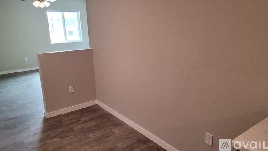 A room with a wooden floor and a window.