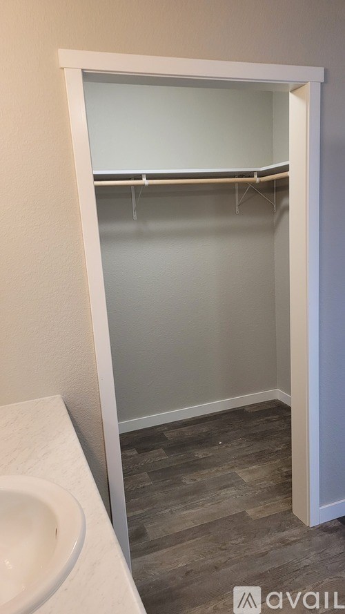 A white sink in a bathroom with a white door.