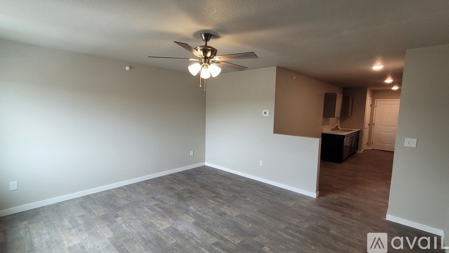 A room with a ceiling fan and a light fixture.