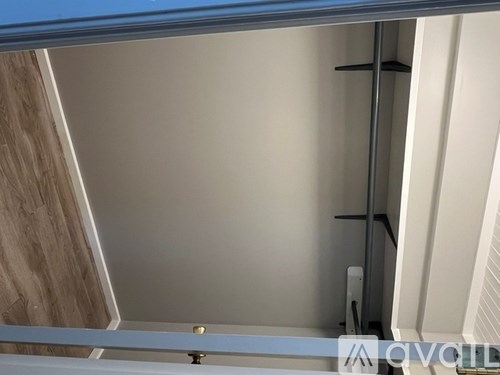 A white door with a silver handle is open.