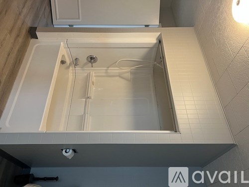 A small white bathroom with a shower.