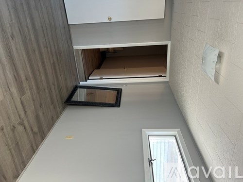 A small room with a cabinet and a mirror on the wall.