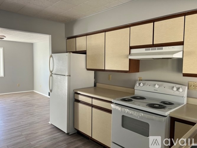 A kitchen with a white refrigerator, stove, and oven.