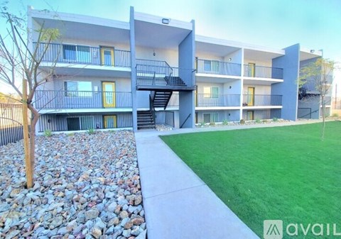 Apartment complex with a stone pathway leading to the entrance.