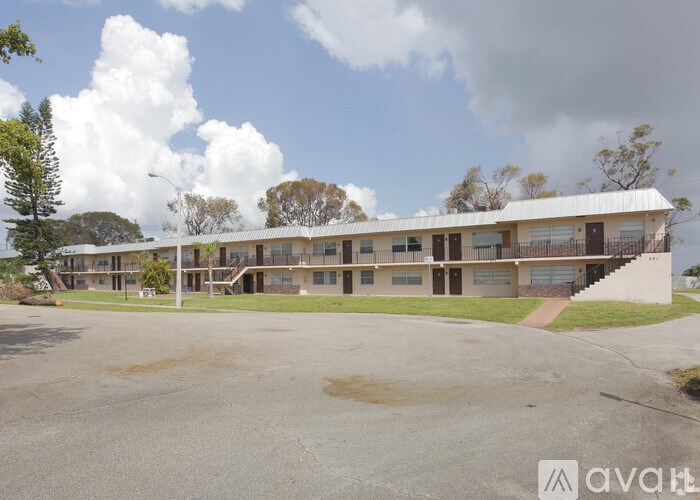 A large building with a parking lot in front of it.