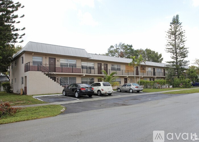 A black car is parked in front of a white car.