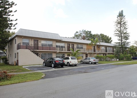 A black car is parked in front of a white car.