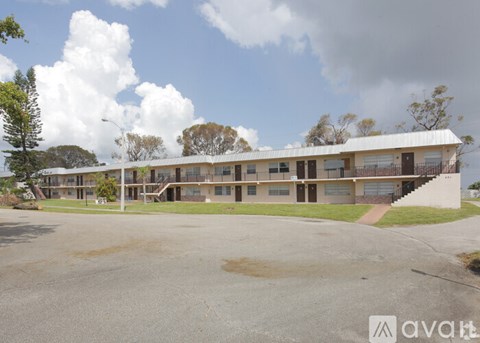 A large building with a parking lot in front of it.