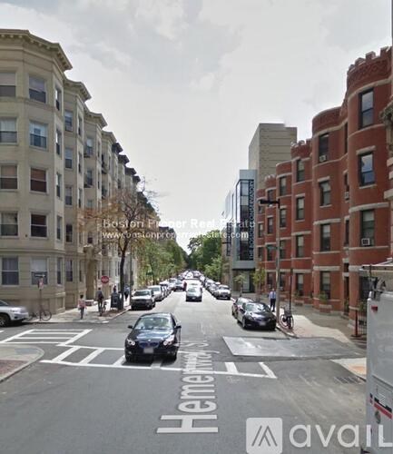 A street view of a city with cars and buildings.