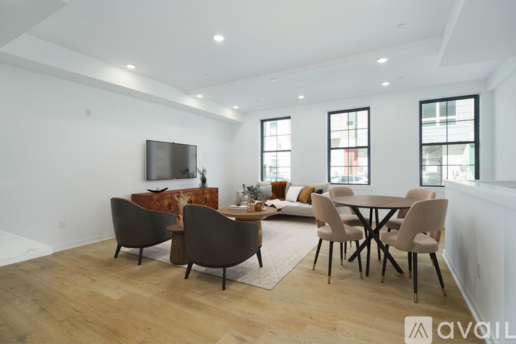 A modern dining room with a wooden table and chairs.