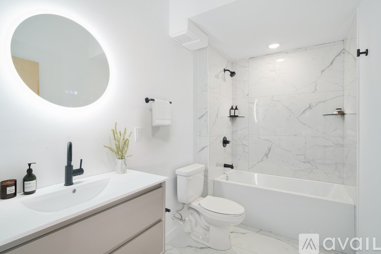 A bathroom with a white toilet, sink, and bathtub.