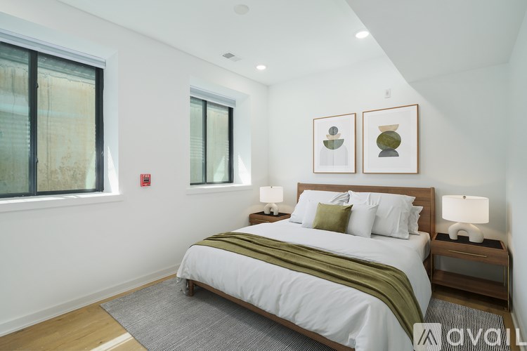 A bedroom with a large bed and two nightstands.