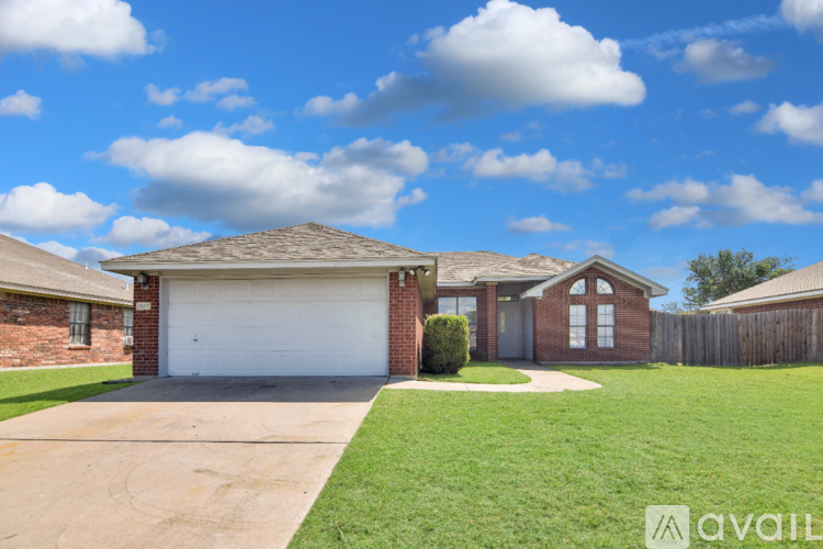 A house with a garage and a driveway is for sale.