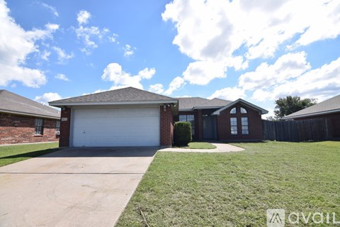 A house with a garage and a driveway is for sale.