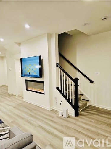A modern living room with a television and a fireplace.