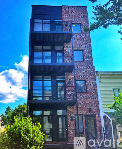 A tall building with a balcony on the second floor.