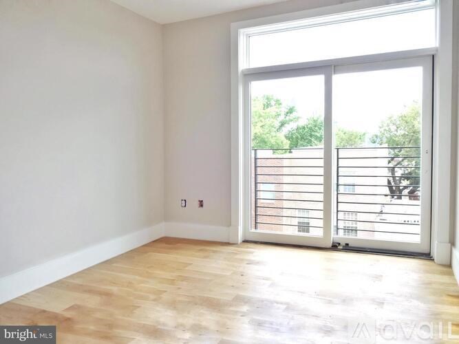 A room with a sliding glass door leading to a balcony.