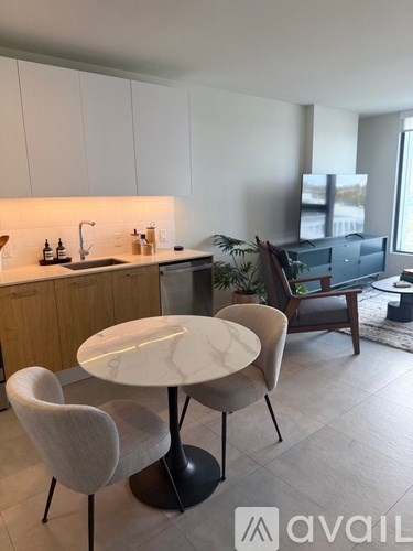 A modern kitchen with a table and chairs.