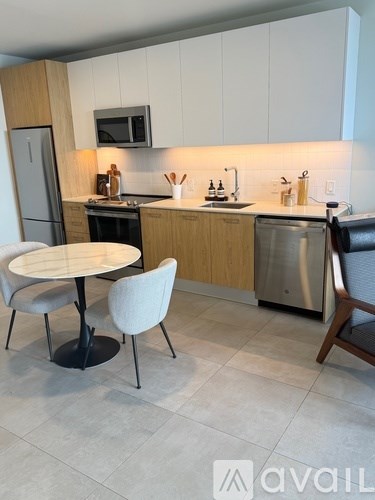 A kitchen with a table and chairs.