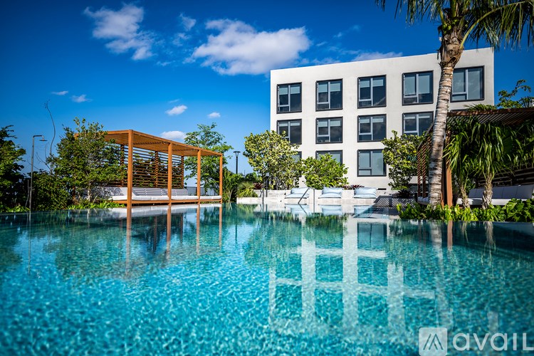 A modern building with a pool in front.