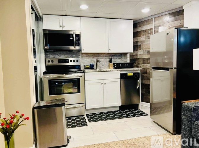 A kitchen with white cabinets and stainless steel appliances.