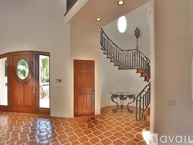 A foyer with a staircase and a table.