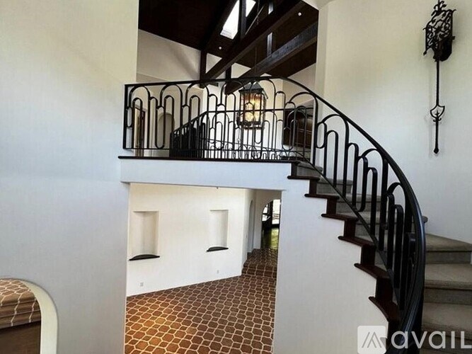 A staircase with a metal railing and a light on it.