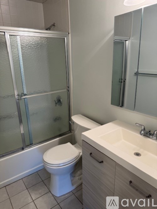 A white toilet sits next to a sink in a bathroom.