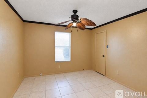 A room with a ceiling fan and a window.