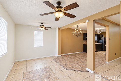 A living room with a ceiling fan and a chandelier.