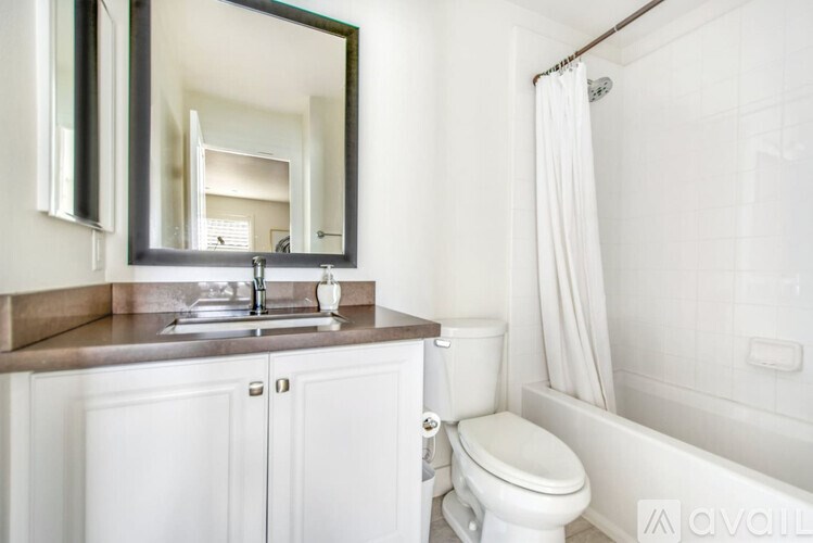 A bathroom with a sink, toilet, and bathtub.