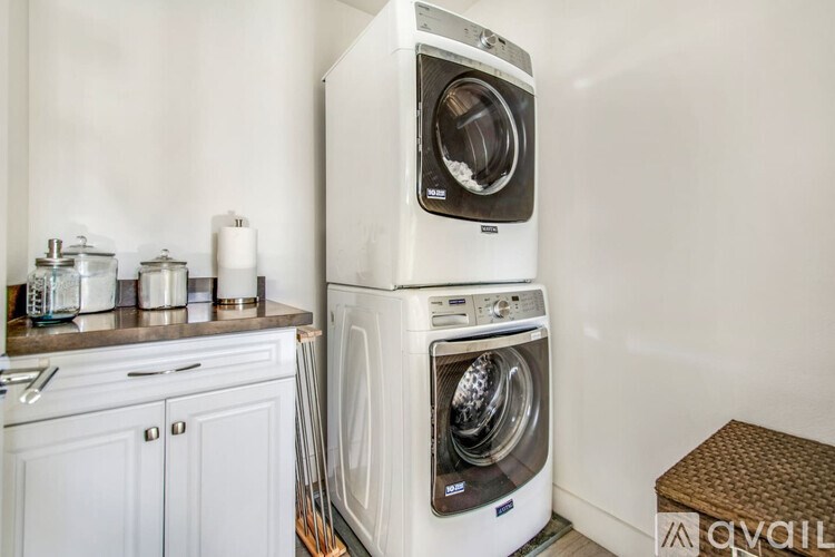 A white washing machine and dryer in a laundry room.