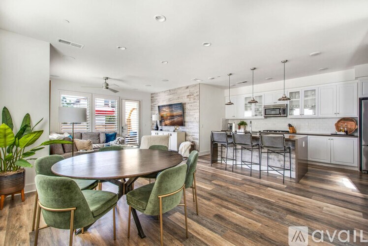 A modern kitchen with a dining table and chairs.