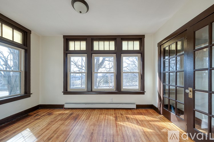A room with wooden floors and a large window.