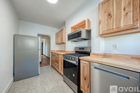 A kitchen with wooden cabinets and stainless steel appliances.