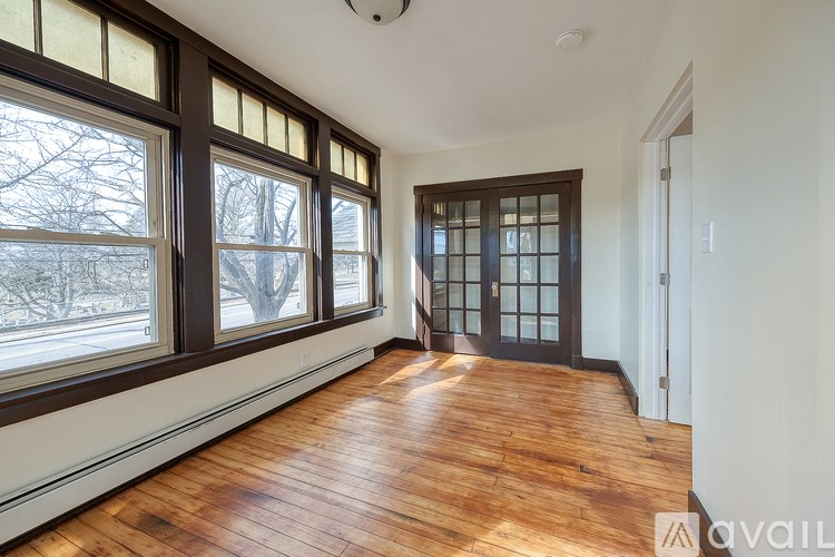 A room with wooden floors and large windows.