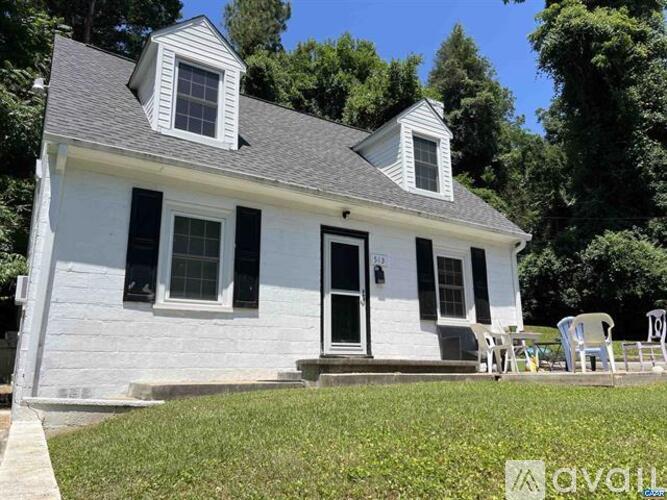 A white house with a black door and windows.
