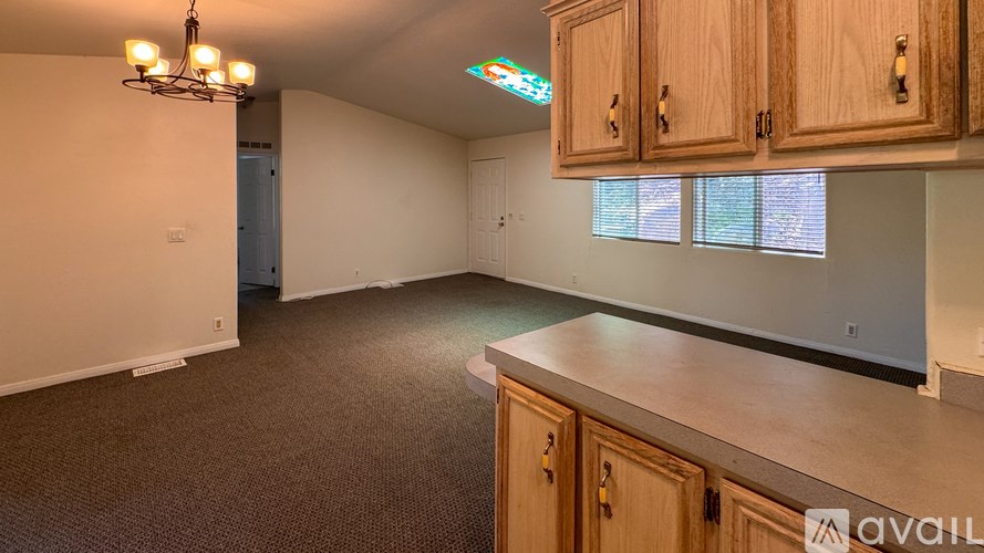 A kitchen with wooden cabinets and a stove top oven.
