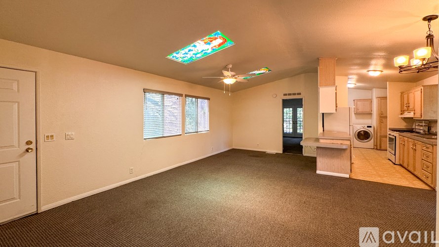 A room with a desk, a window, and a closet.