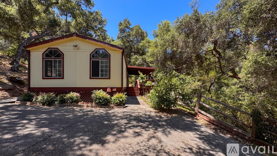 A white bathroom with a tub, toilet, and sink.