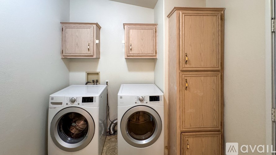 A small house is surrounded by trees and rocks.