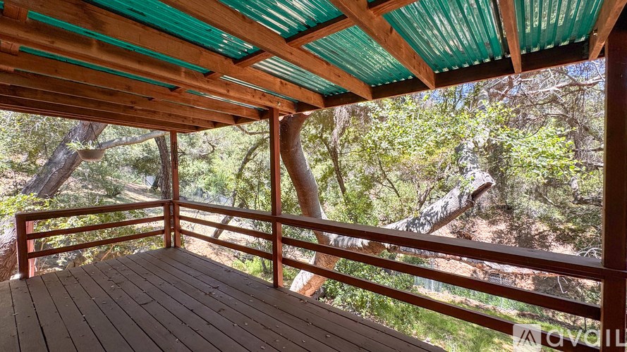 A room with a ceiling fan and two windows.