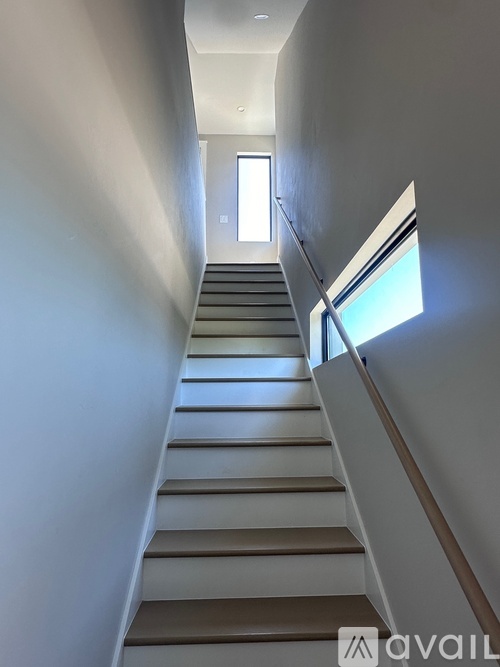 A staircase with a window on the side.