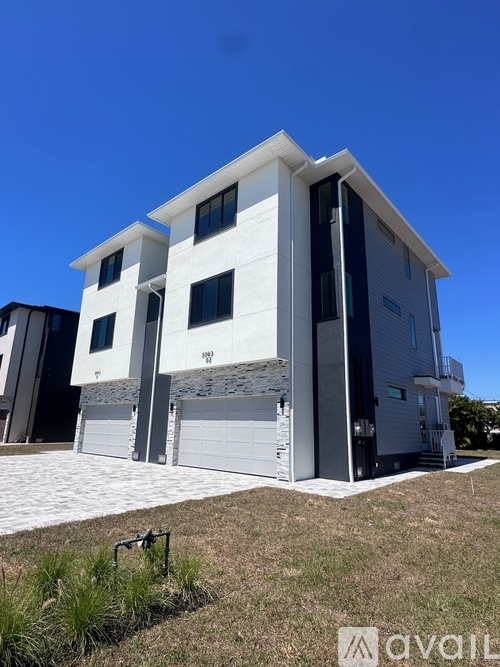 A modern two-story house with a white exterior and a garage.