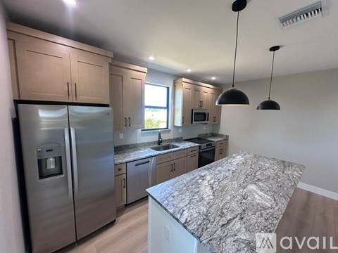 A kitchen with granite countertops and stainless steel appliances.