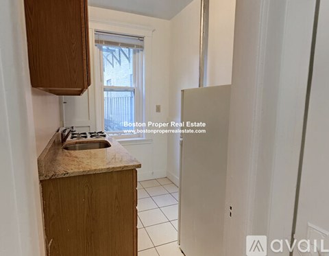 A kitchen with a wooden counter and a window.