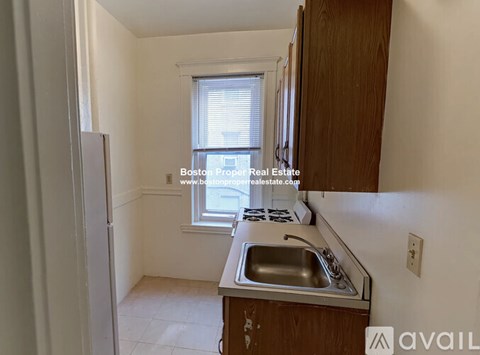 A kitchen with a sink and a window.