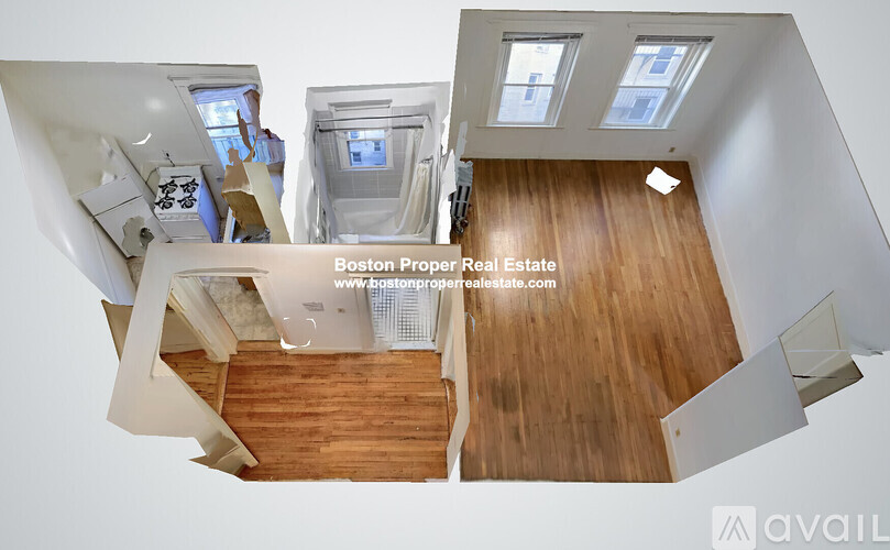 A top-down view of a modern interior space with wooden floors and white walls.