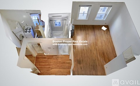 A top-down view of a modern interior space with wooden floors and white walls.