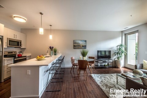 A modern kitchen with a dining table and chairs.